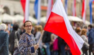 Женщина учащаяся на бесплатных курсах польского языка, держит в руках флаг Польши-RU